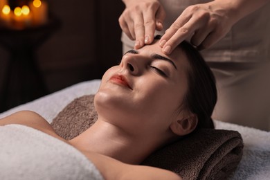 Attractive woman enjoying face massage, closeup. Beauty procedure