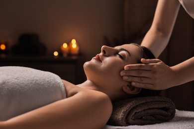 Photo of Attractive woman enjoying face massage, closeup. Beauty procedure