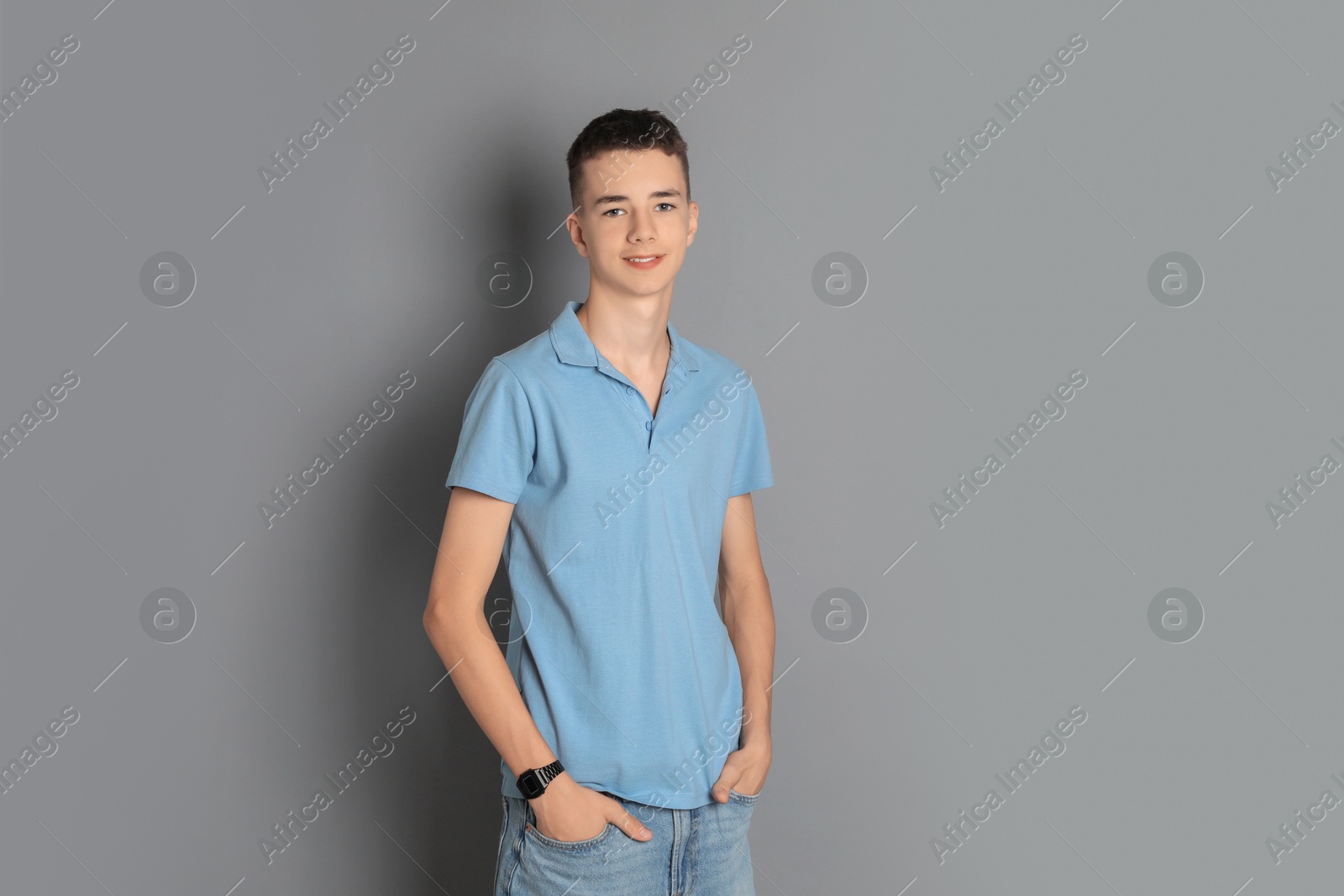 Photo of Portrait of teenage boy on grey background, space for text