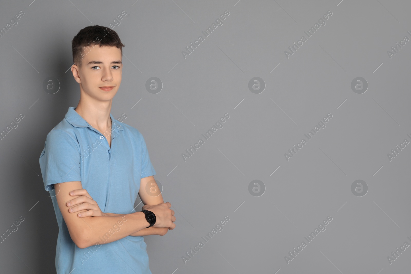 Photo of Portrait of teenage boy on grey background, space for text