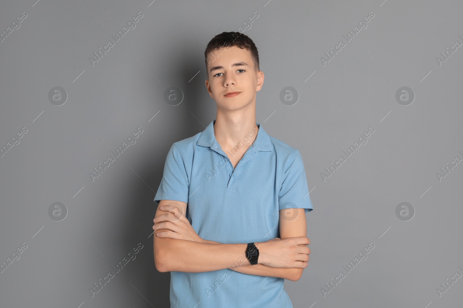 Photo of Portrait of teenage boy on grey background