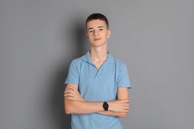 Photo of Portrait of teenage boy on grey background