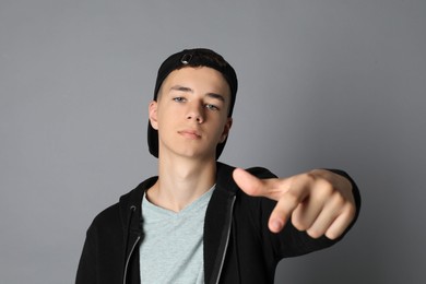 Photo of Portrait of teenage boy on grey background