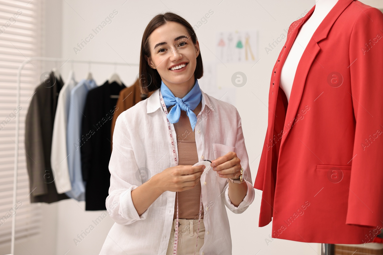 Photo of Fashion designer with needles working in workshop