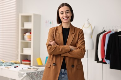 Photo of Portrait of happy fashion designer in workshop