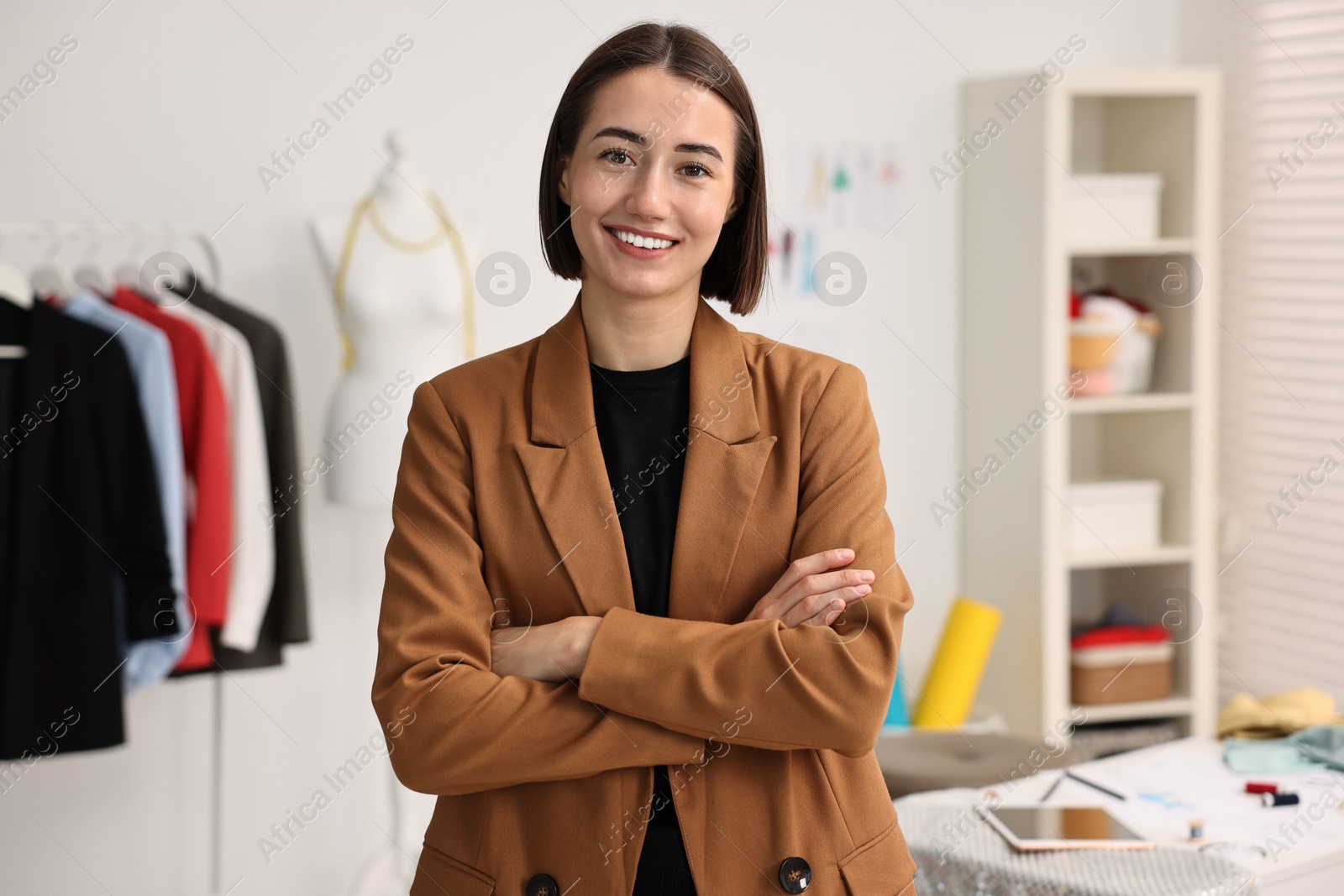 Photo of Portrait of happy fashion designer in workshop