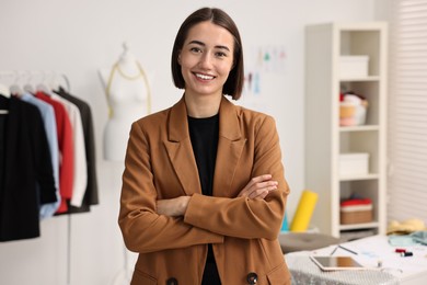 Portrait of happy fashion designer in workshop