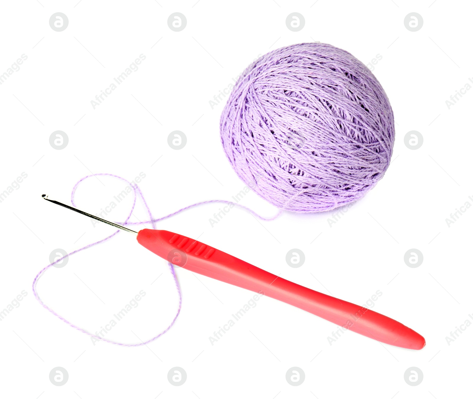 Photo of Ball of violet yarn and crochet hook isolated on white