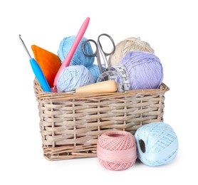 Photo of Colorful yarns, crochet hooks, scissors and measuring tape in wicker basket isolated on white