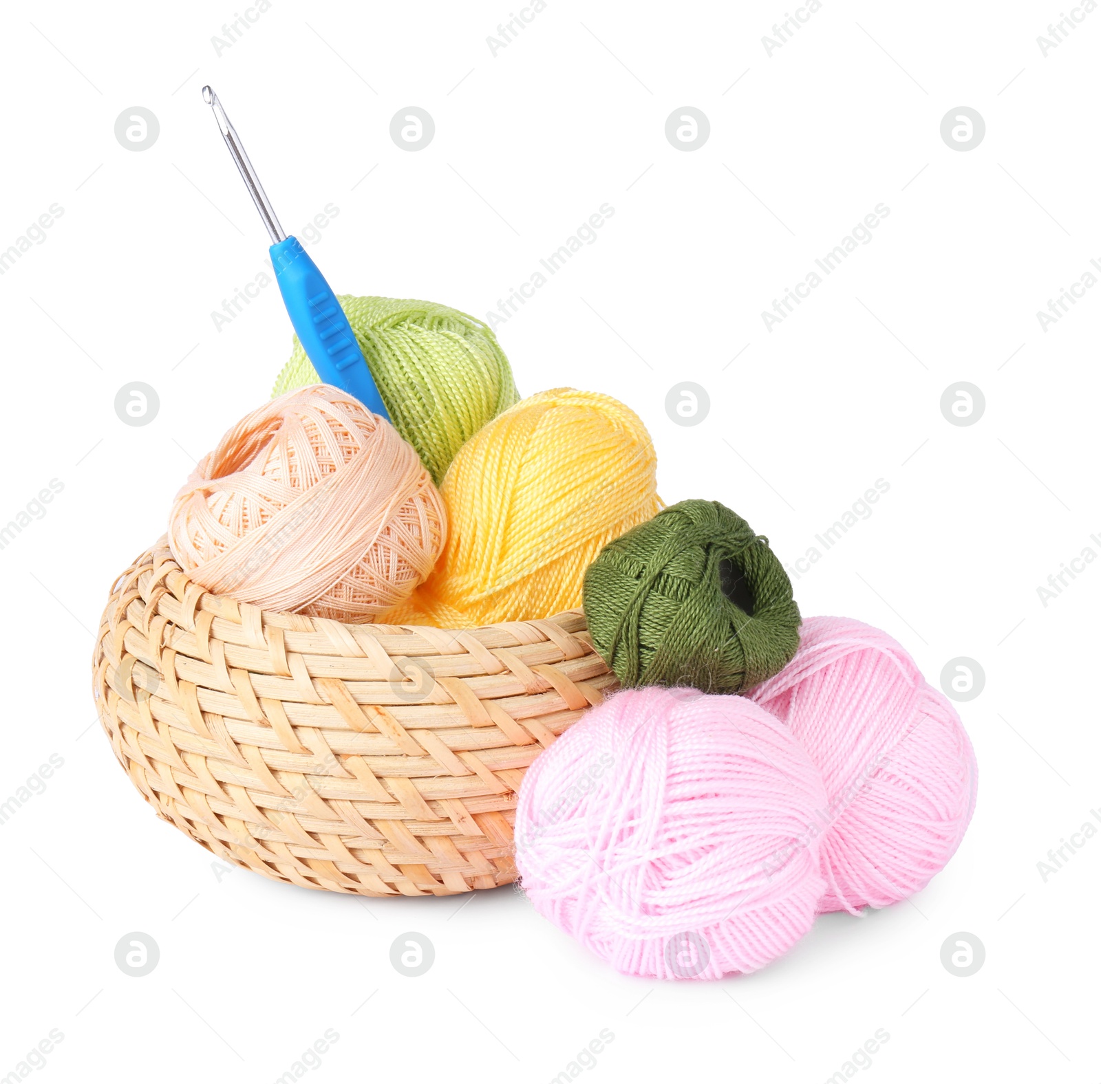 Photo of Colorful yarns and crochet hook in wicker basket isolated on white