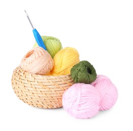 Photo of Colorful yarns and crochet hook in wicker basket isolated on white