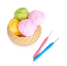 Photo of Colorful yarns and crochet hooks in wicker basket isolated on white