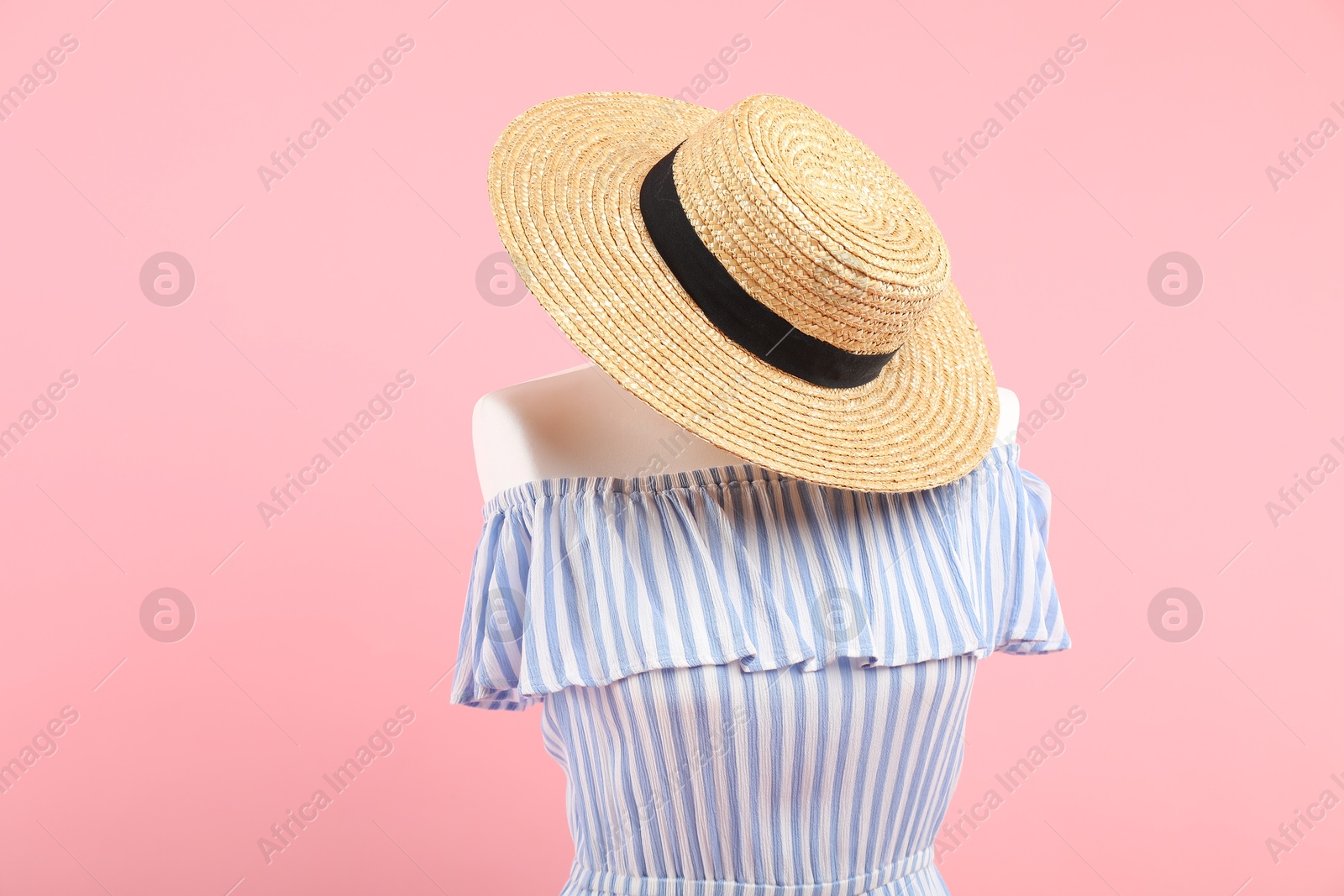 Photo of Mannequin with stylish dress and hat on pink background