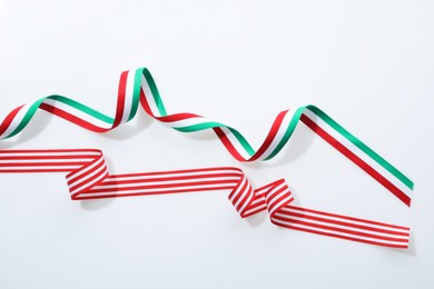 Two colorful striped ribbons on white background, top view