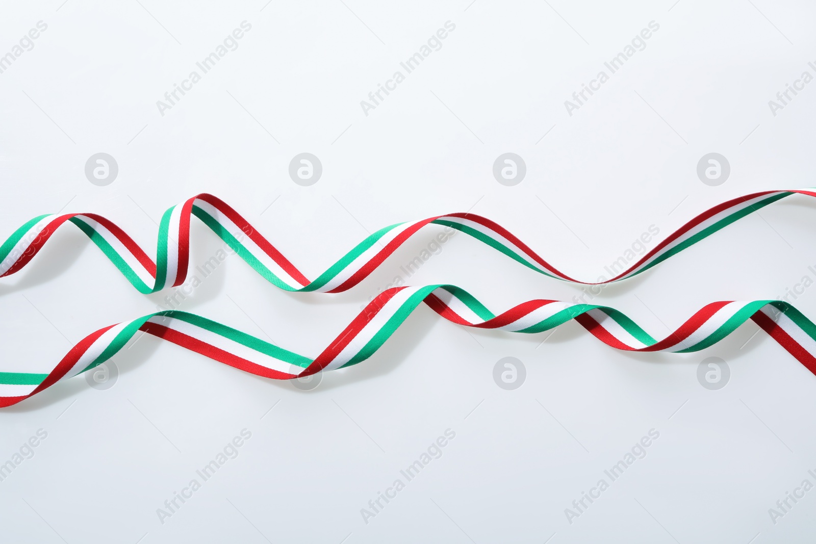 Photo of Ribbons in colors of Italian flag isolated on white, top view