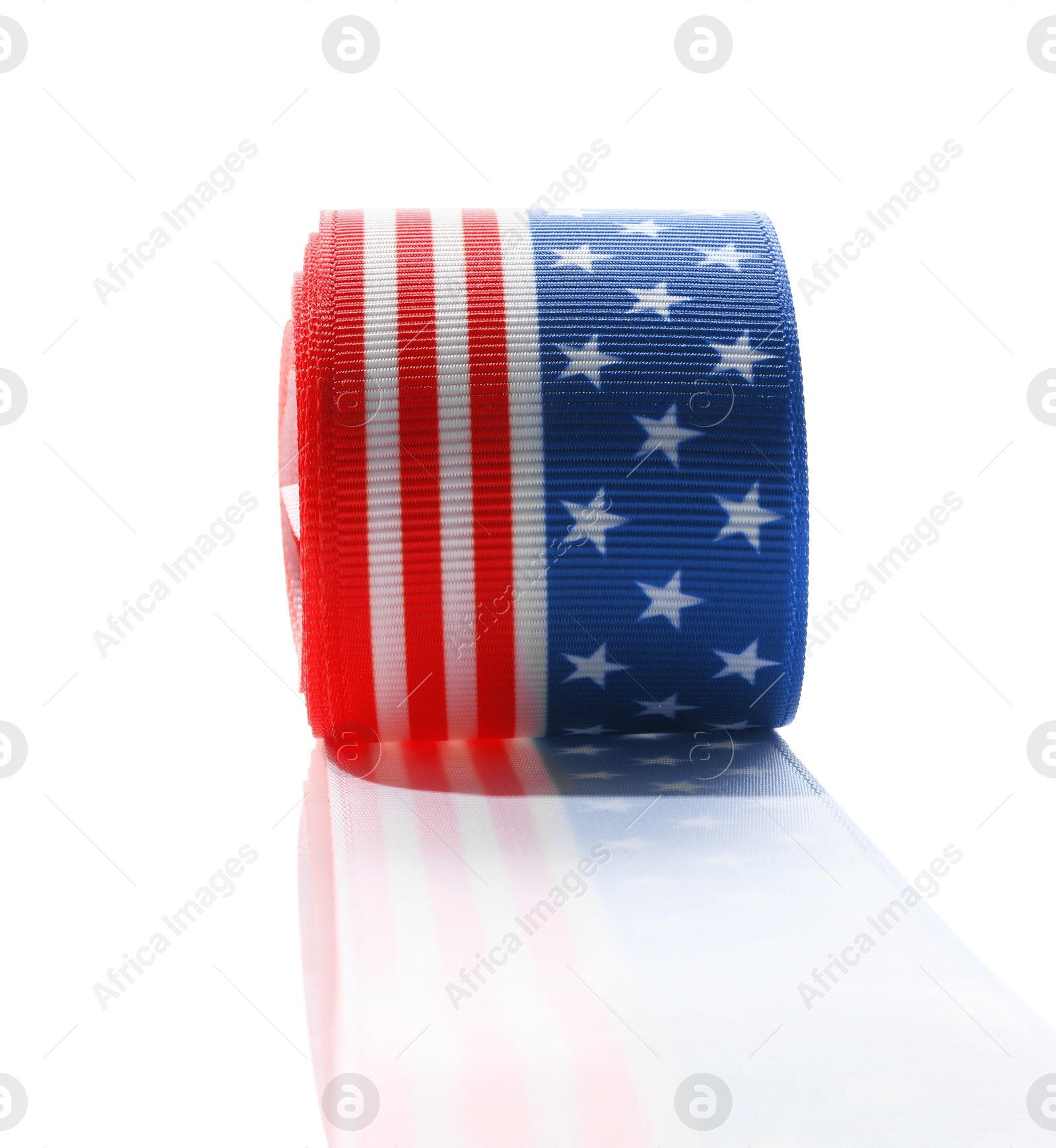 Photo of Roll with ribbon in colors of American flag isolated on white