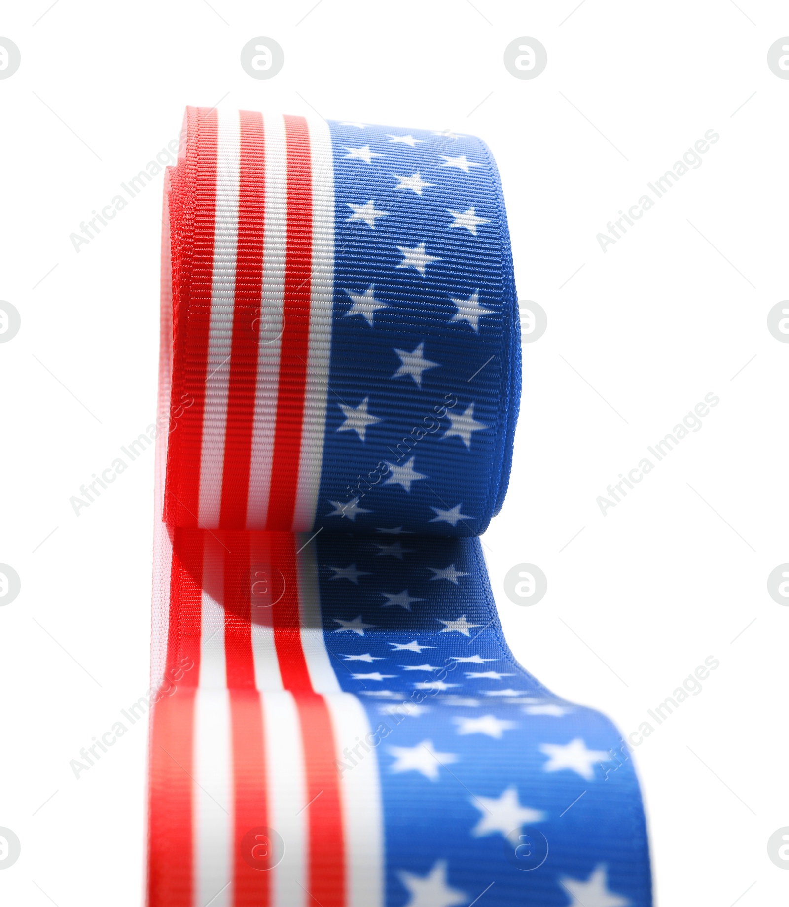 Photo of Roll with ribbon in colors of American flag isolated on white