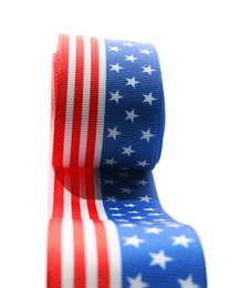 Photo of Roll with ribbon in colors of American flag isolated on white