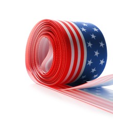 Photo of Roll with ribbon in colors of American flag isolated on white