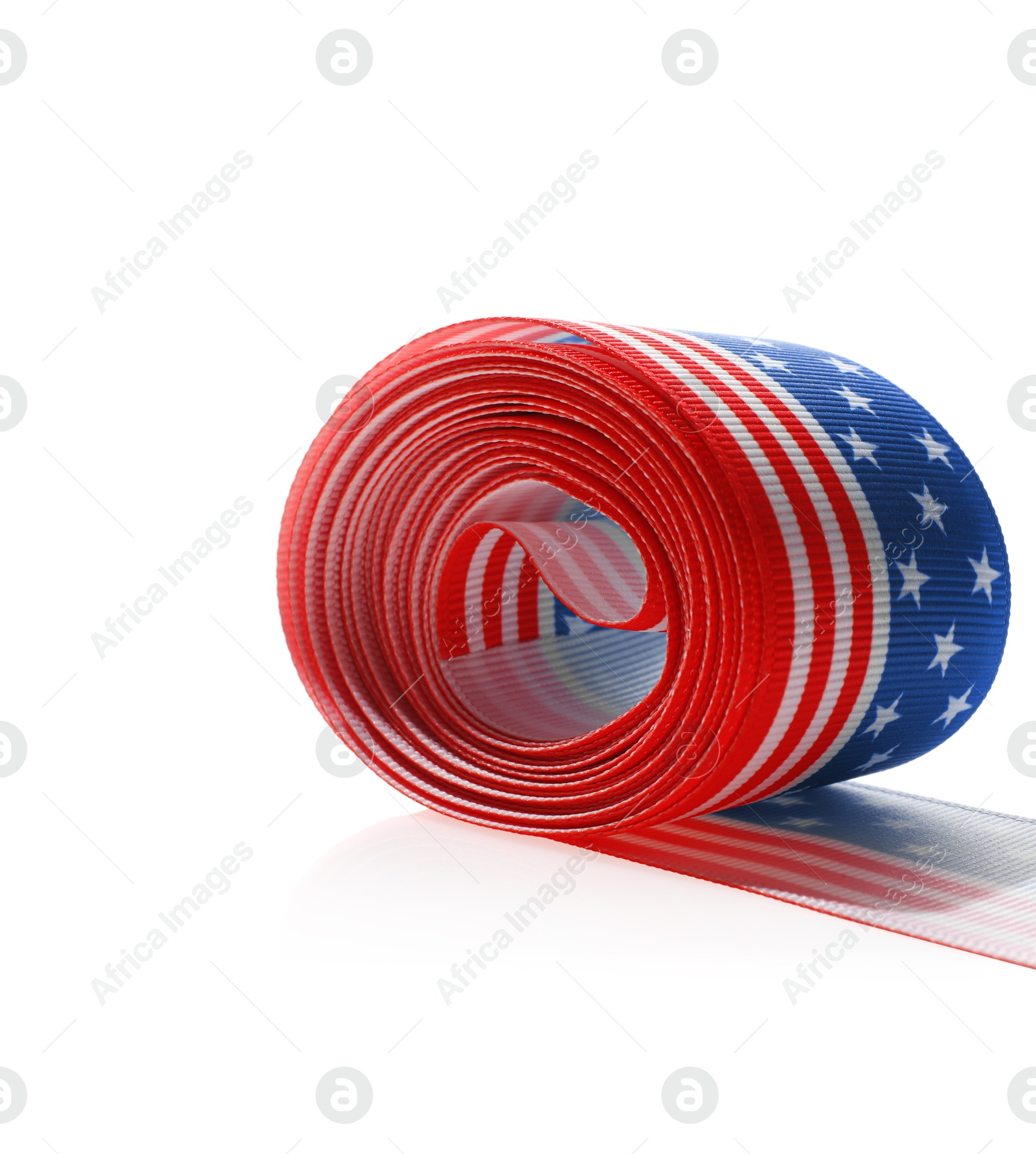 Photo of Roll with ribbon in colors of American flag isolated on white