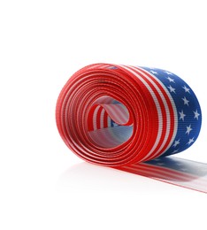 Photo of Roll with ribbon in colors of American flag isolated on white