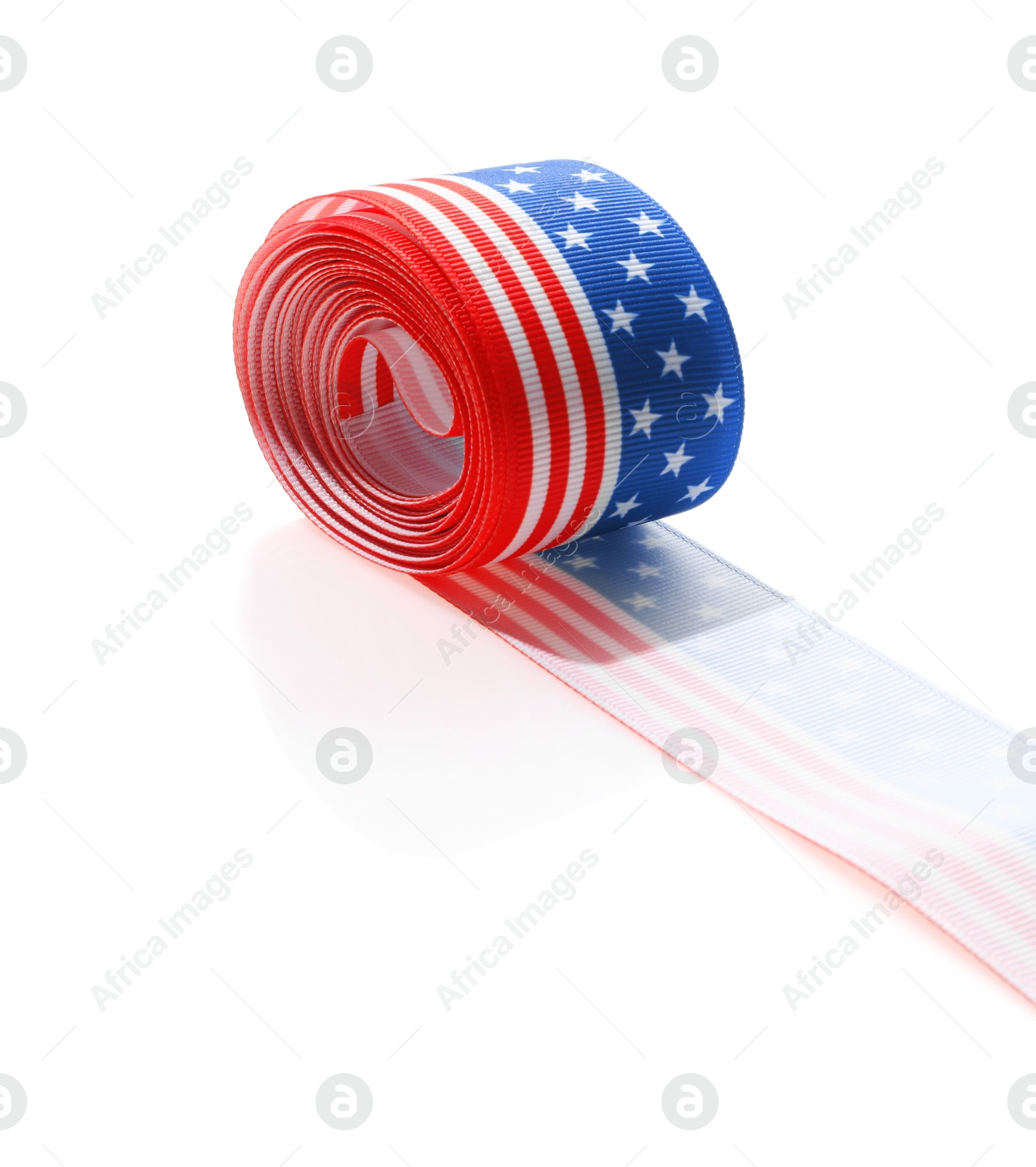 Photo of Roll with ribbon in colors of American flag isolated on white