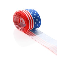 Photo of Roll with ribbon in colors of American flag isolated on white