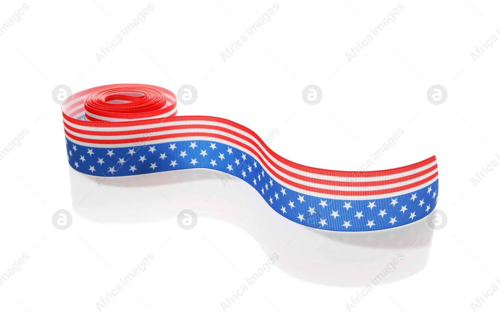 Photo of Roll with ribbon in colors of American flag isolated on white