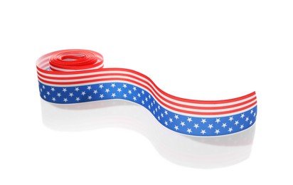 Photo of Roll with ribbon in colors of American flag isolated on white