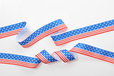 Ribbons in colors of American flag on white background, top view