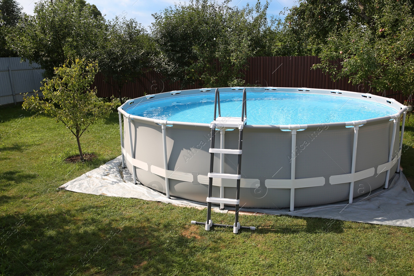 Photo of Above ground swimming pool outdoors on sunny day