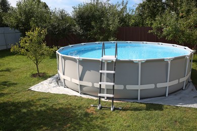 Above ground swimming pool outdoors on sunny day