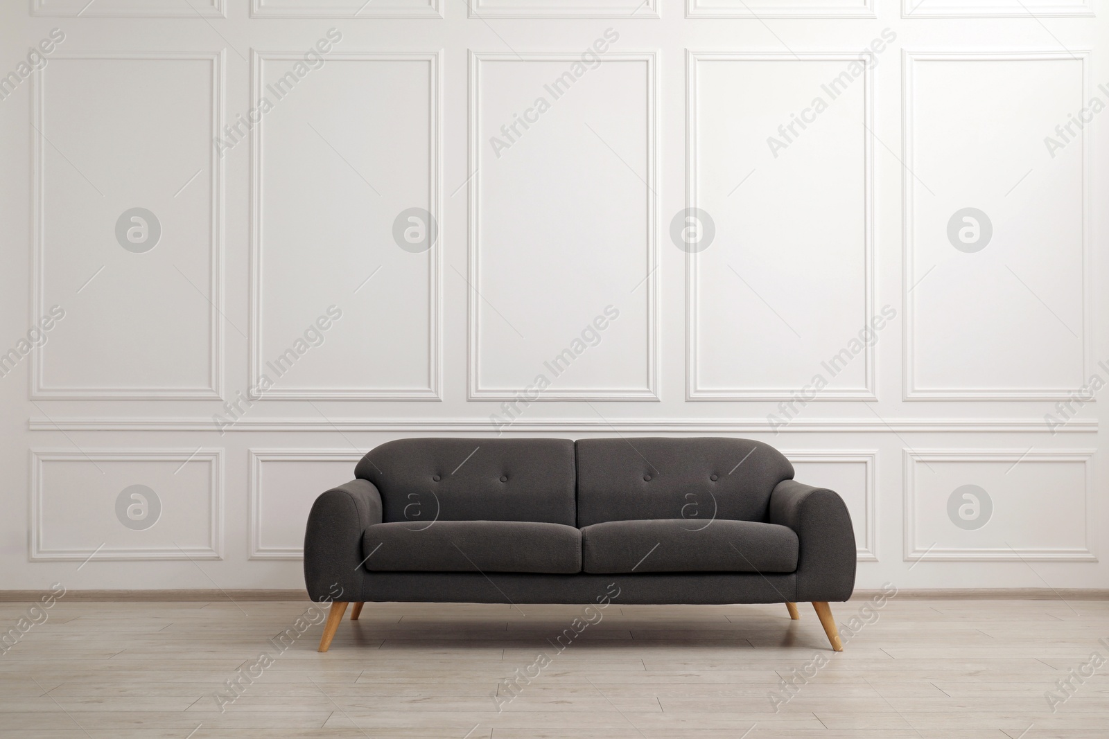 Photo of Comfortable gray sofa in living room. Interior design