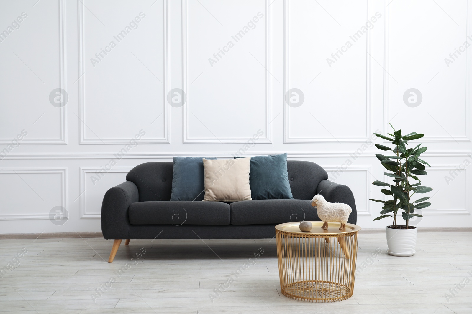 Photo of Comfortable gray sofa with cushions in living room. Interior design