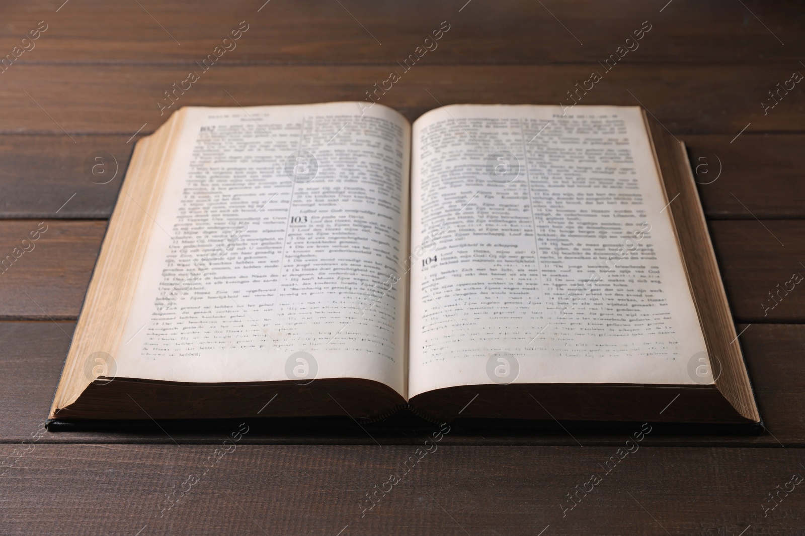 Photo of Open Bible on wooden table. Christian faith