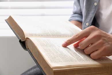 Photo of Man with Bible indoors, closeup. Christian faith