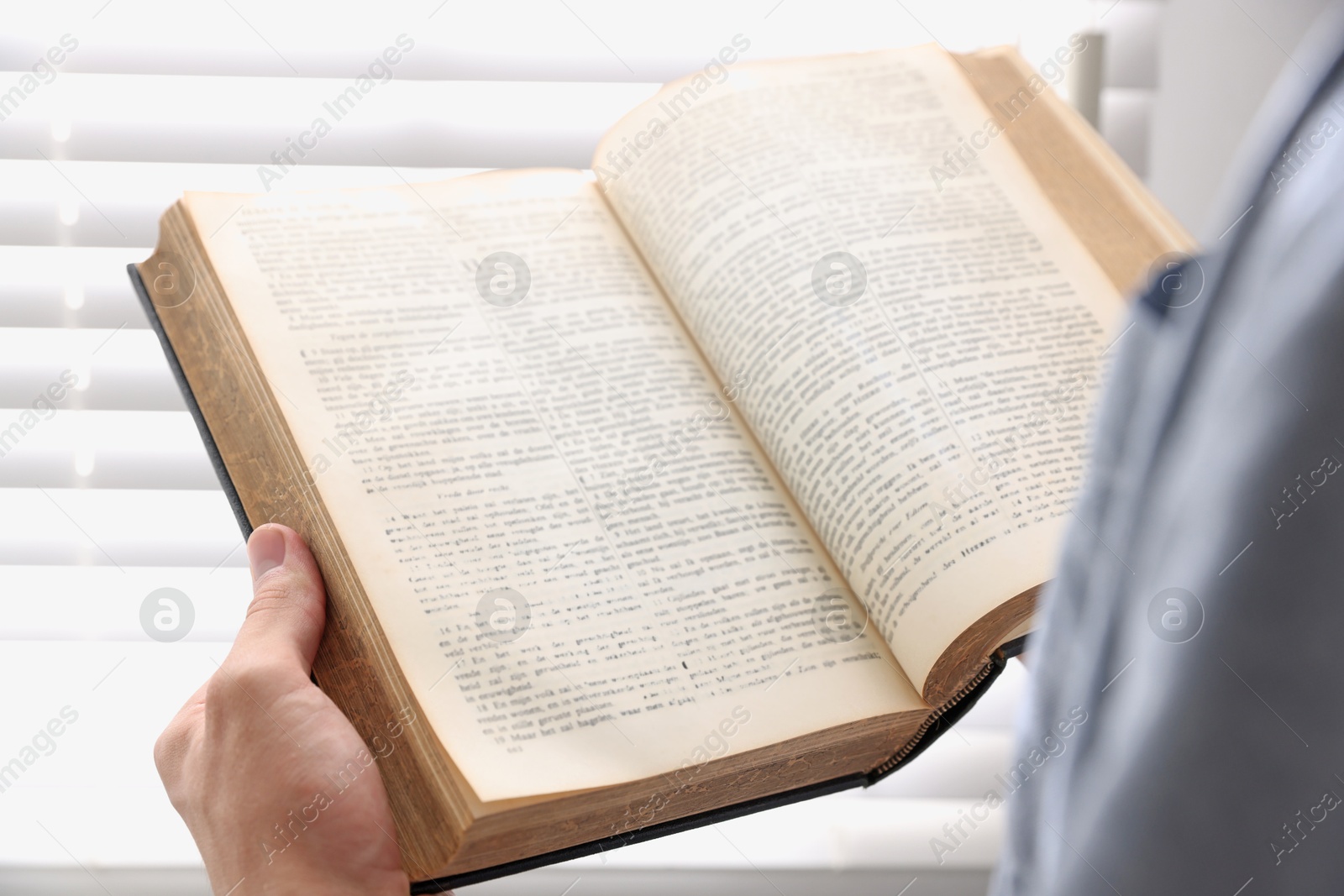 Photo of Man with Bible indoors, closeup. Christian faith