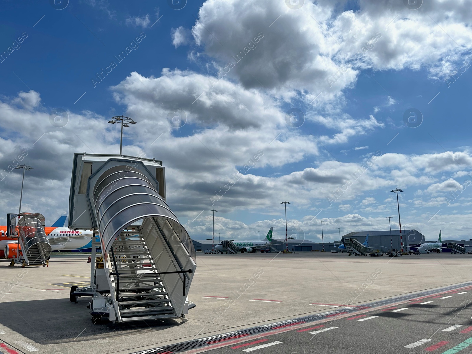 Photo of Rotterdam, Netherlands - July 22, 2024: Boarding stairs and modern airplanes in Rotterdam The Hague Airport