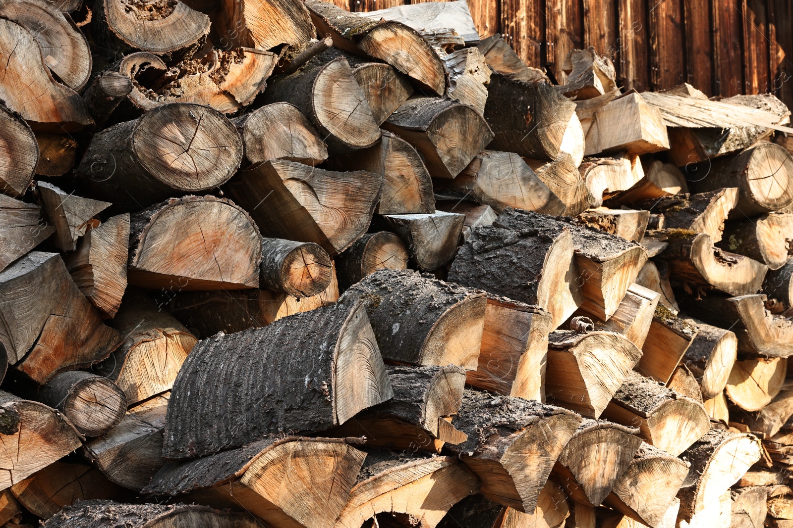 Photo of Pile of cut firewood outdoors, closeup view