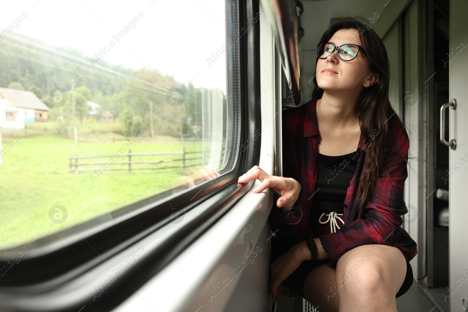 Photo of Beautiful woman looking out of train window during trip