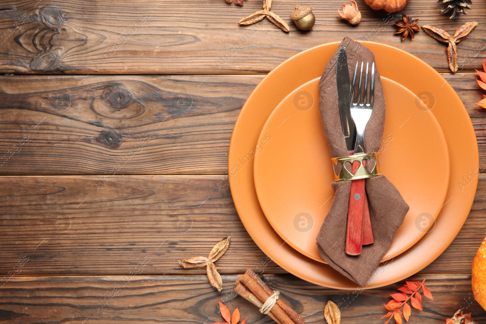 Photo of Stylish place setting and autumn decor on wooden table. Space for text