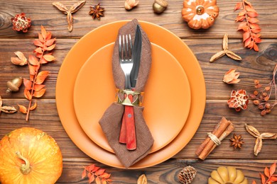 Photo of Stylish place setting and autumn decor on wooden table