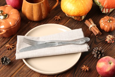 Photo of Stylish place setting with autumn decor on wooden table