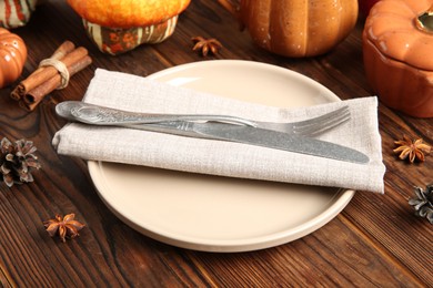 Photo of Stylish place setting with autumn decor on wooden table