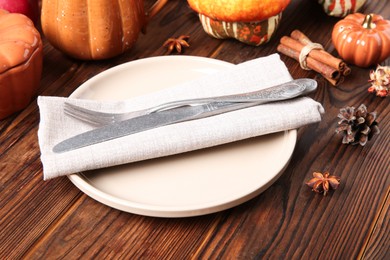 Stylish place setting with autumn decor on wooden table