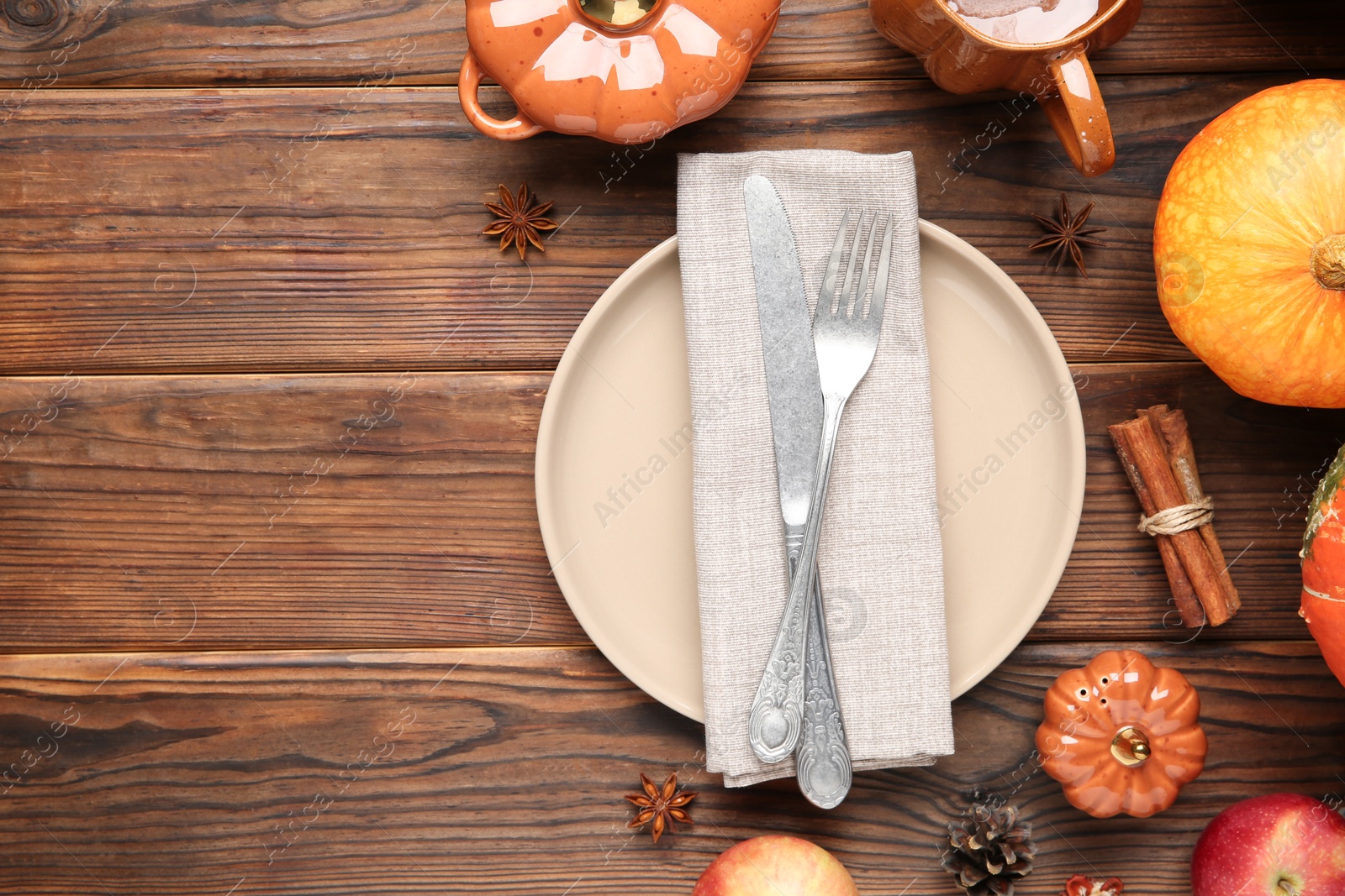 Photo of Stylish place setting and autumn decor on wooden table. Space for text