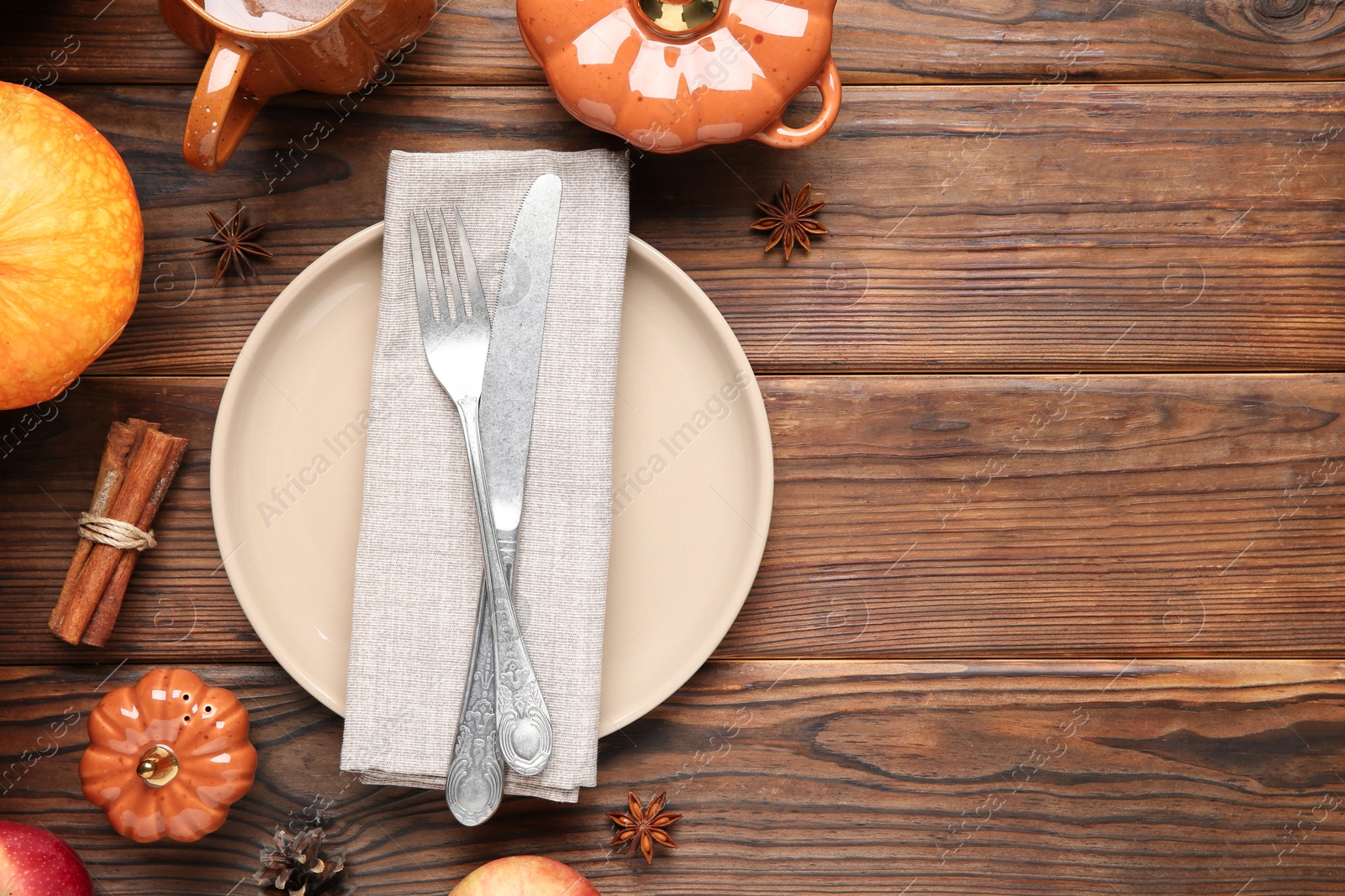 Photo of Stylish place setting and autumn decor on wooden table. Space for text