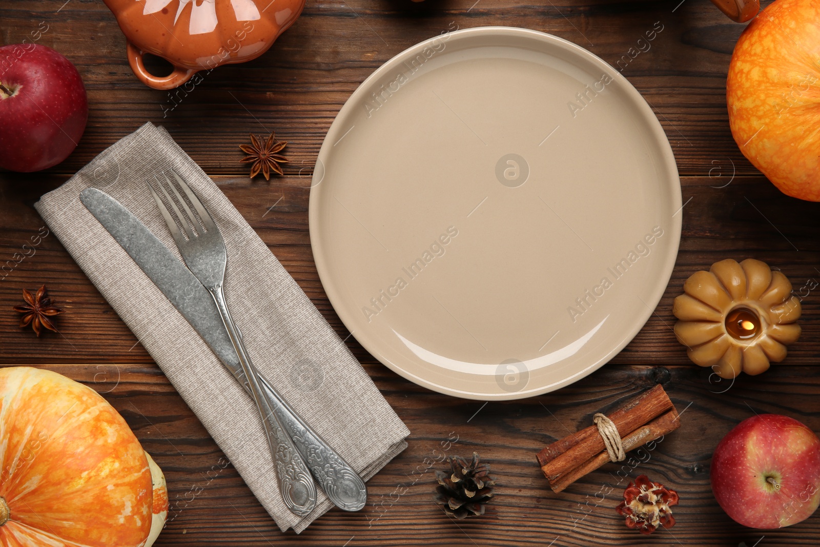 Photo of Stylish place setting and autumn decor on wooden table