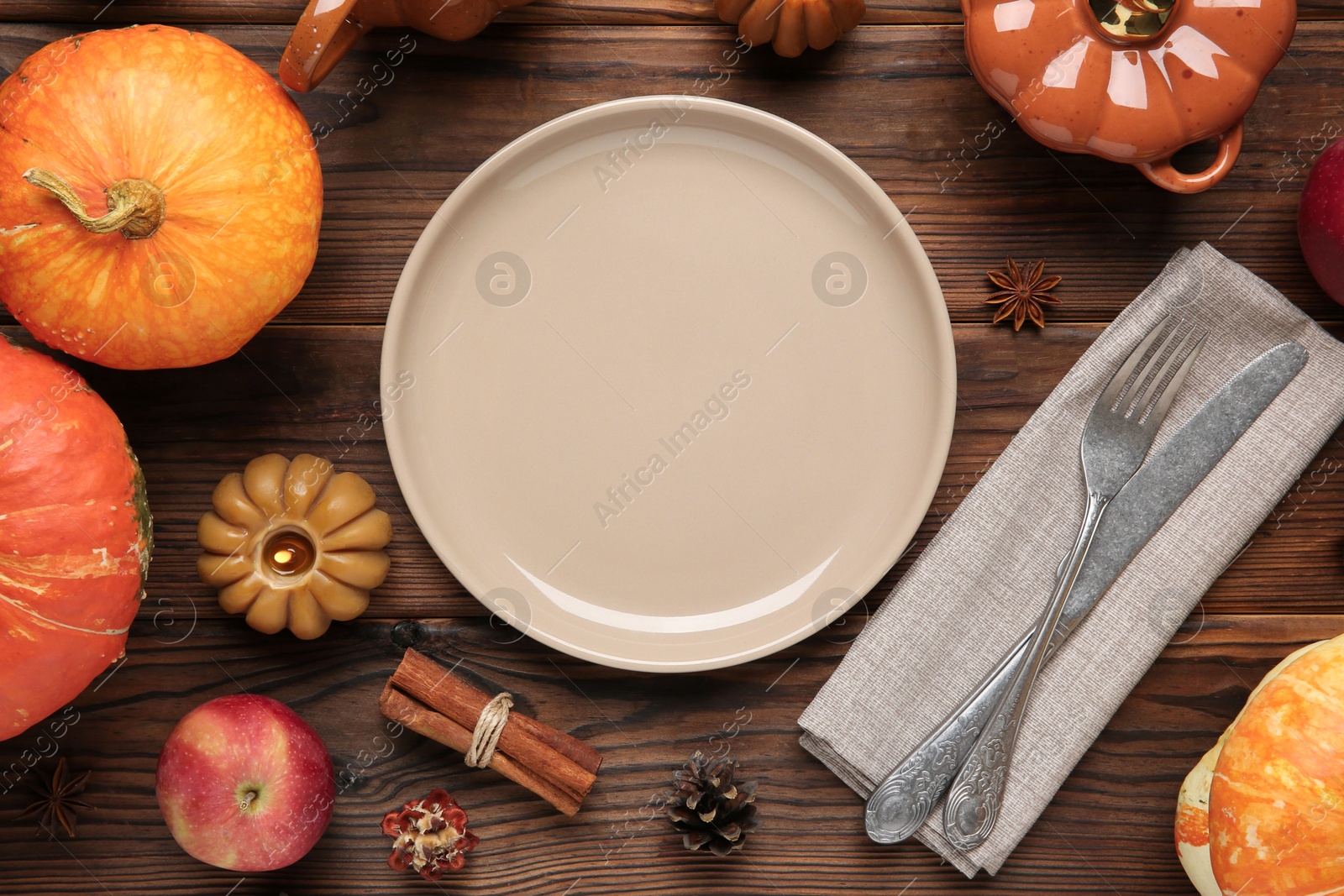 Photo of Stylish place setting and autumn decor on wooden table