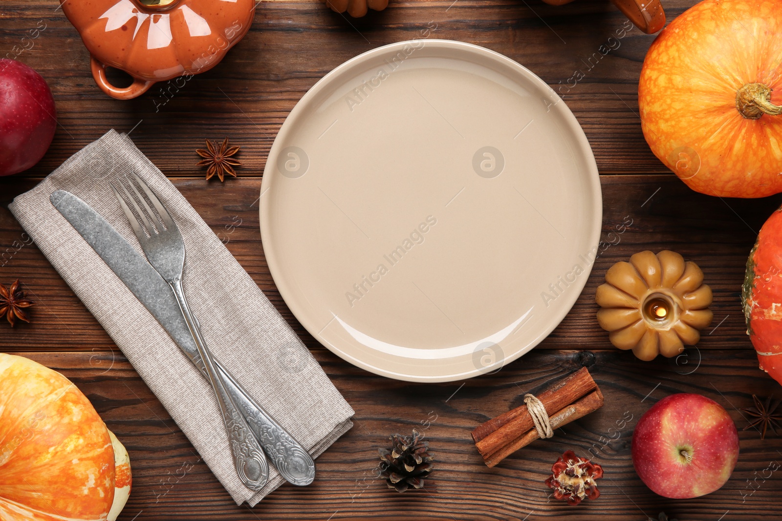 Photo of Stylish place setting and autumn decor on wooden table